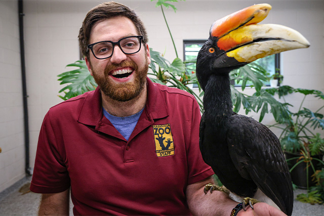 Jake Belair, Ambassador Animal Lead Keeper, with a bird